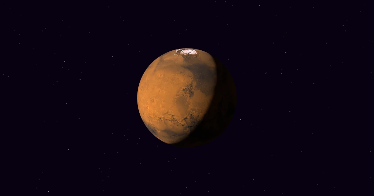 Mars, photographed whole by NASA's Viking orbiters, lit from the upper left so its right side falls into shadow, in deep space with faint stars