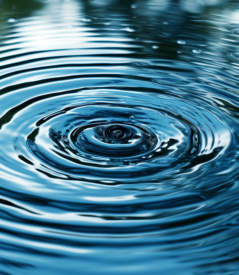 An image of a water drop causing resonance on a pond.